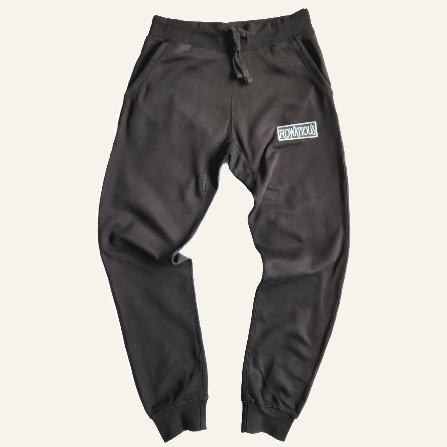 Flowatious Platinum Black Box sweatpants front view. Embroidered Flowatious boxed logo on the left side. 